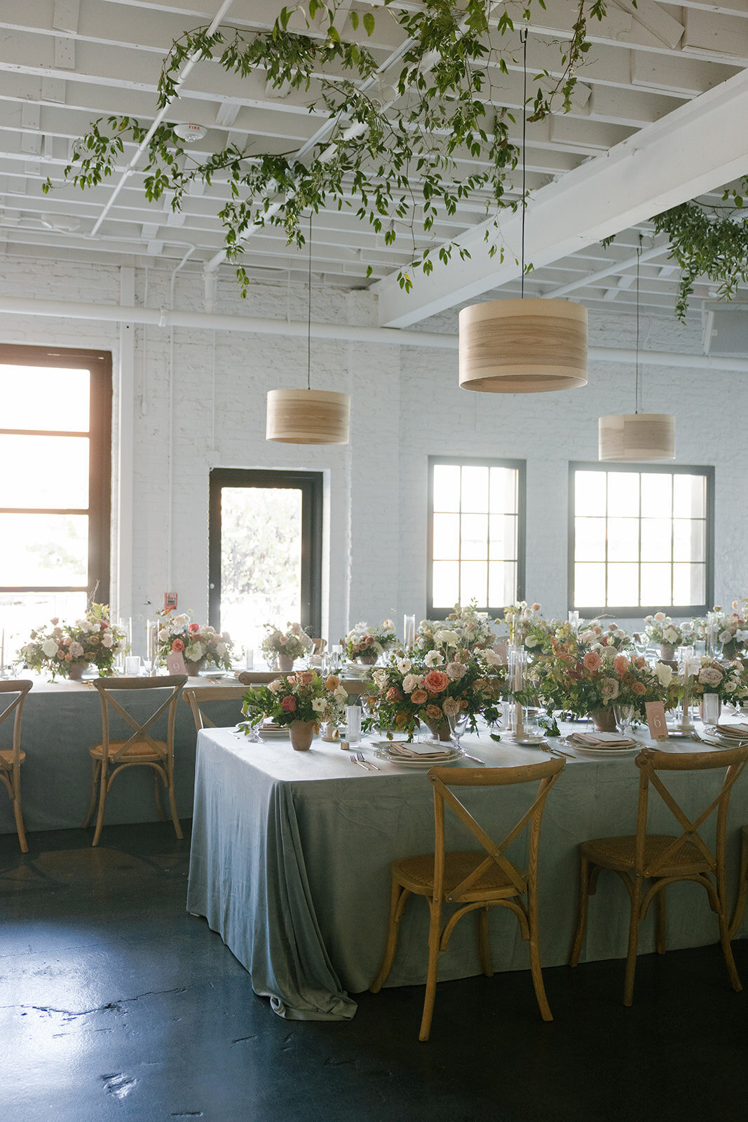 Fall reception table floral arrangements in colors of mauve, cream, dusty rose, dusty blue, taupe, and natural green. Autumn floral consisting of roses, rain tree pods, fall branches, clematis, and greenery. North Carolina wedding design by Rosemary and Finch floral design based in Nashville, TN.