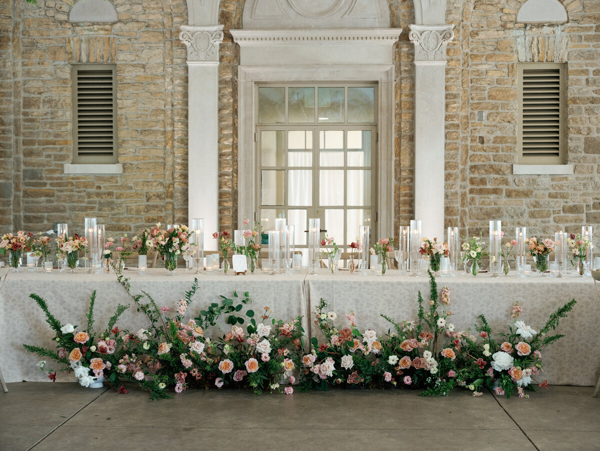 floral adorned table at wedding reception.