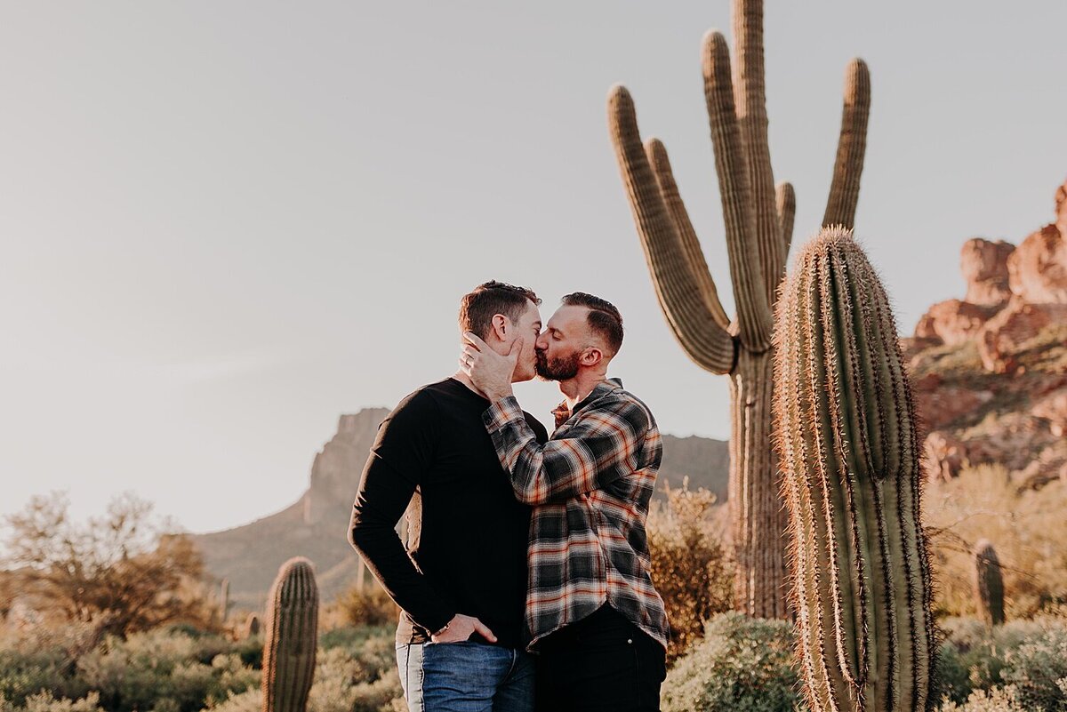 engagement photos with two men kissing in the desert