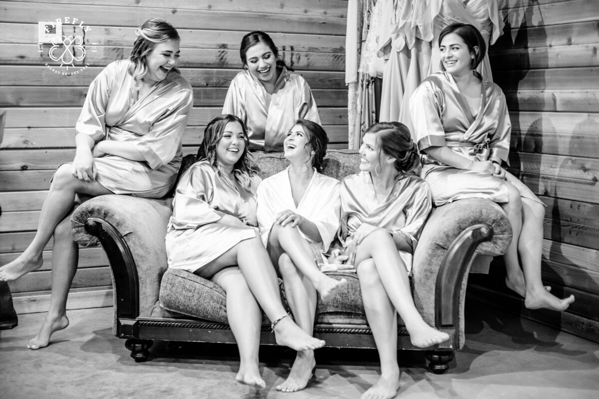 couch in bridal suite with robes at Geronimo Oaks a Hill Country wedding venue taken by Texas wedding photographer Firefly Photographer
