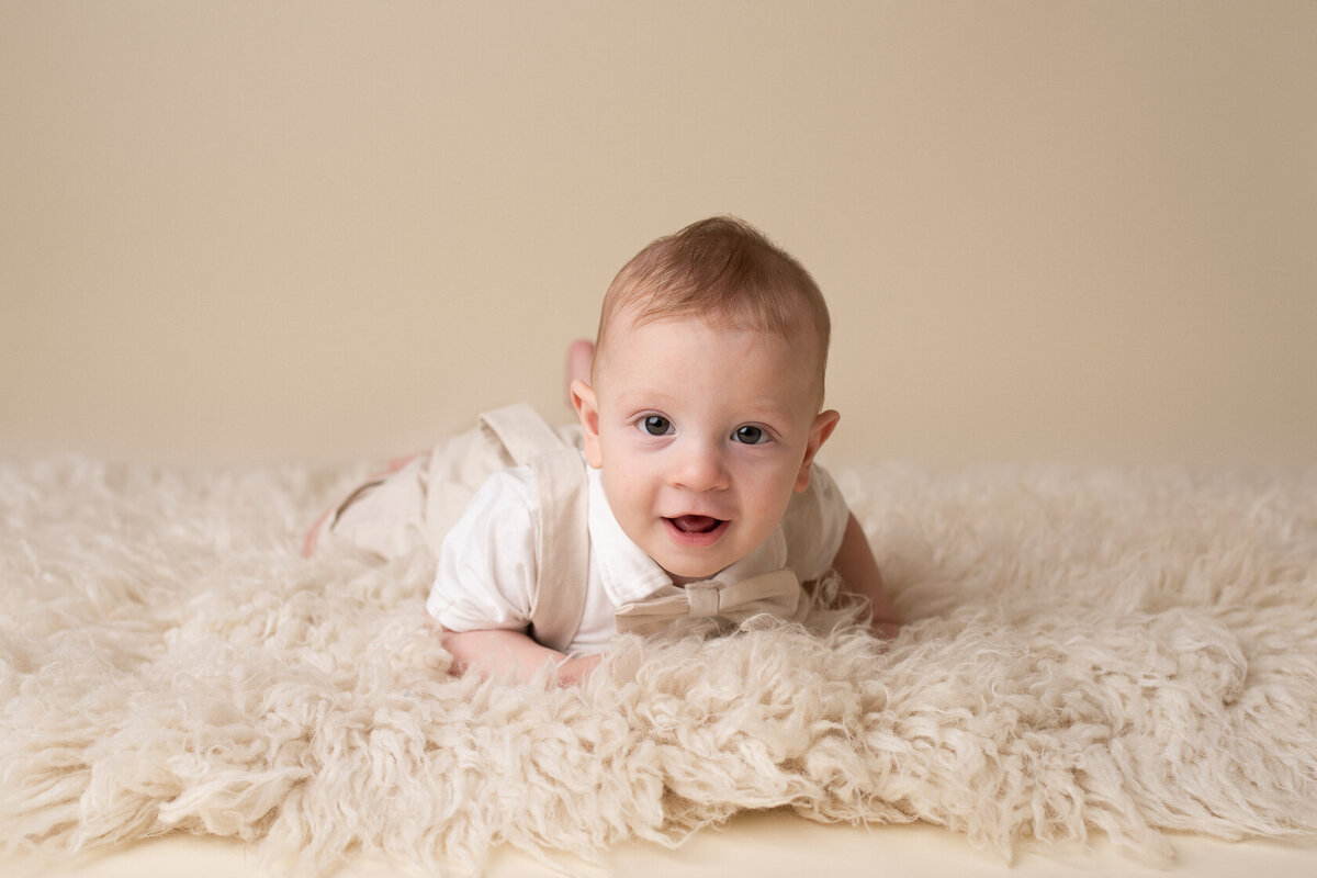 Adorable baby in a cream furry background captured by Laura King, Houston Photographer