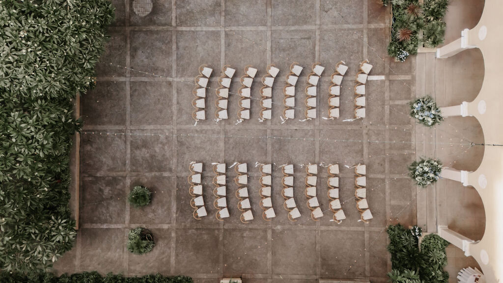 drone view of wishbone ceremony chairs at cafe julia hawaii