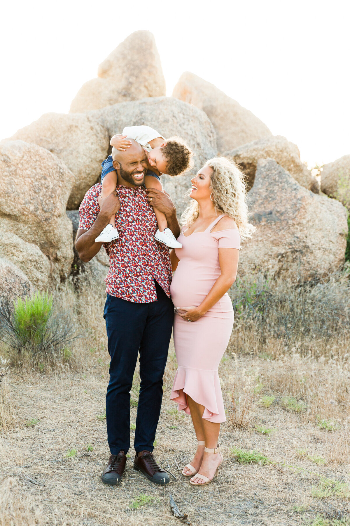 family smiling together for maternity photo