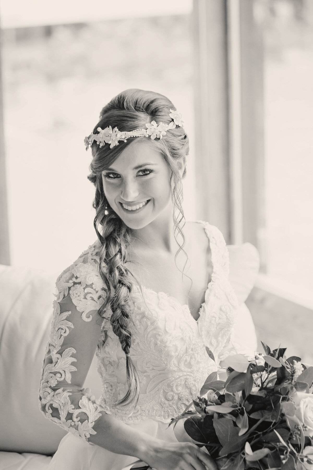 Smiling bride with floral head piece.