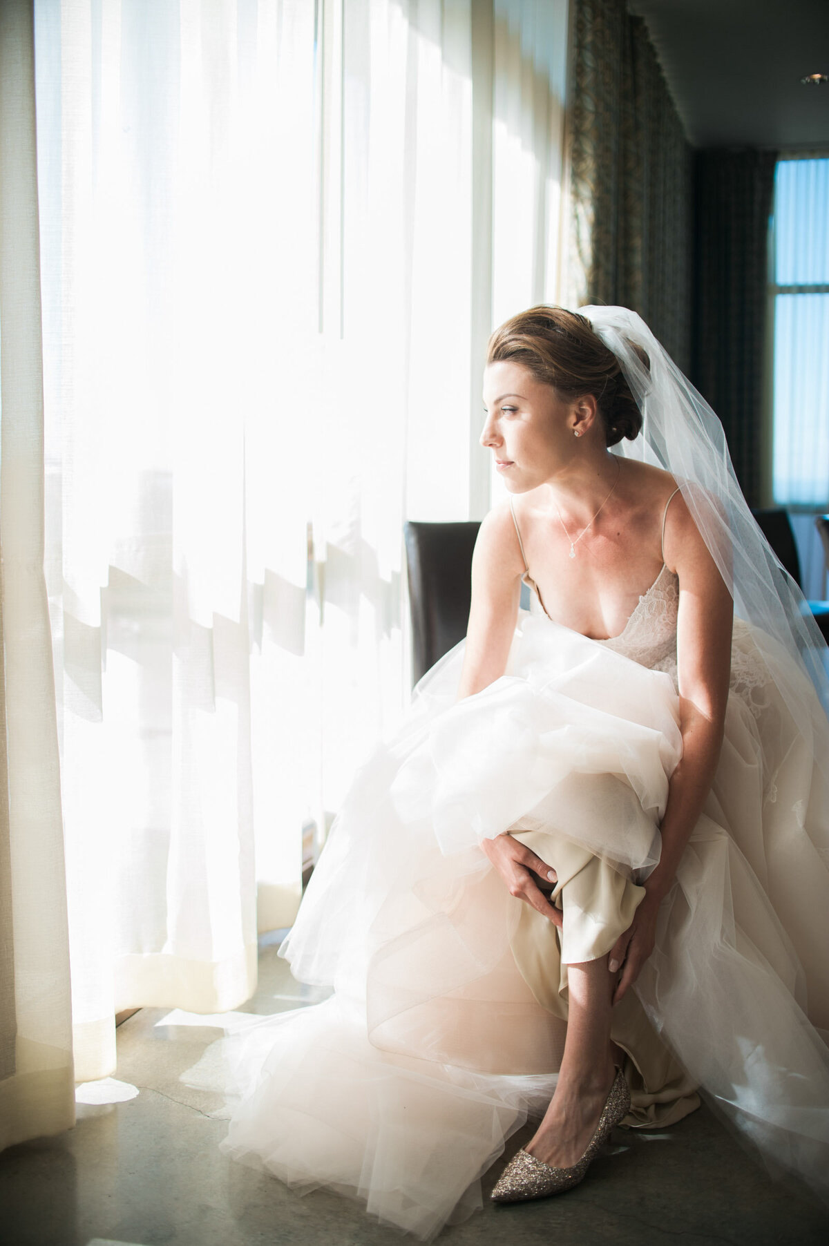 bride putting on her jimmy choo shoes at ponzi vineyard