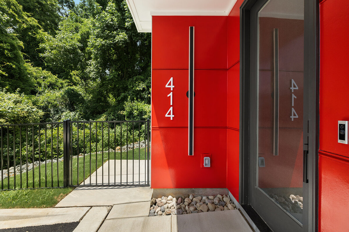 Red exterior accents on modern townhouse