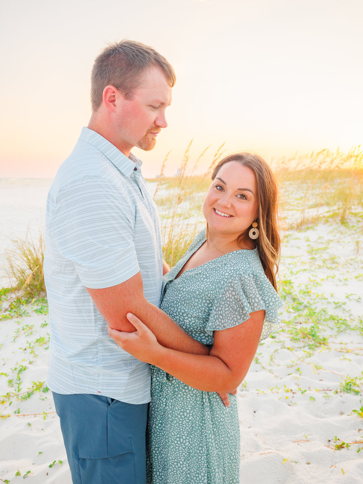 couple holding each other in an embrace during golden hour
