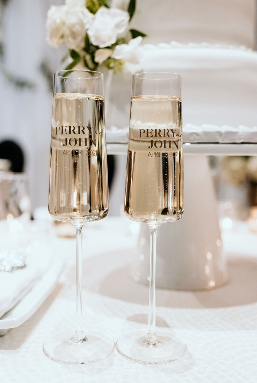 Personalized bride and groom champagne glasses at a spring wedding at the Palm Event Center in Pleasanton, CA.
