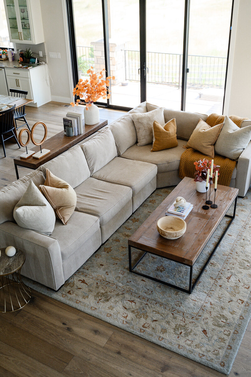 A denver commercial photographer takes interior photos of the living room of a Denver influencer for a branding photography session so she can use the branding photos for her blog and the brand pictures for her website about fashion and home.