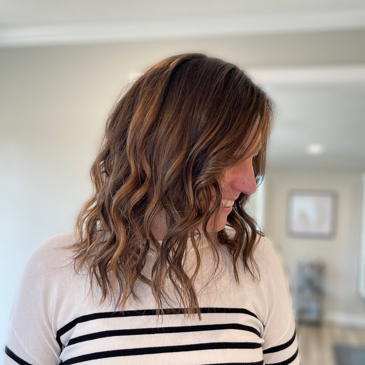 Happy smiling client with fresh balayage highlights