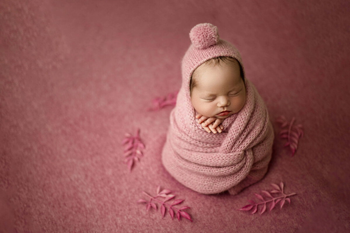 sweet-newborn-girl-in-pink-wrap-maple-grove