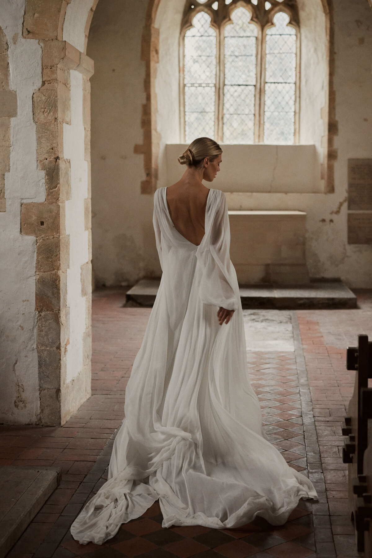Sustainable wedding dress in georgette silk, showing low v back of bride