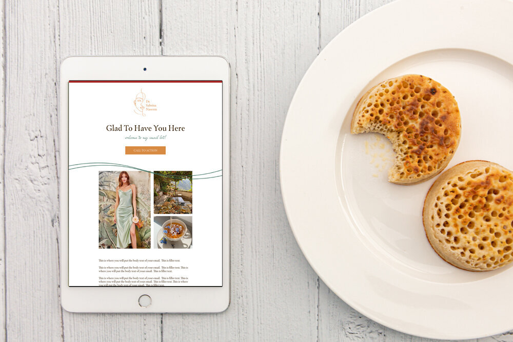 tablet with an email on the screen next to a plate of bread