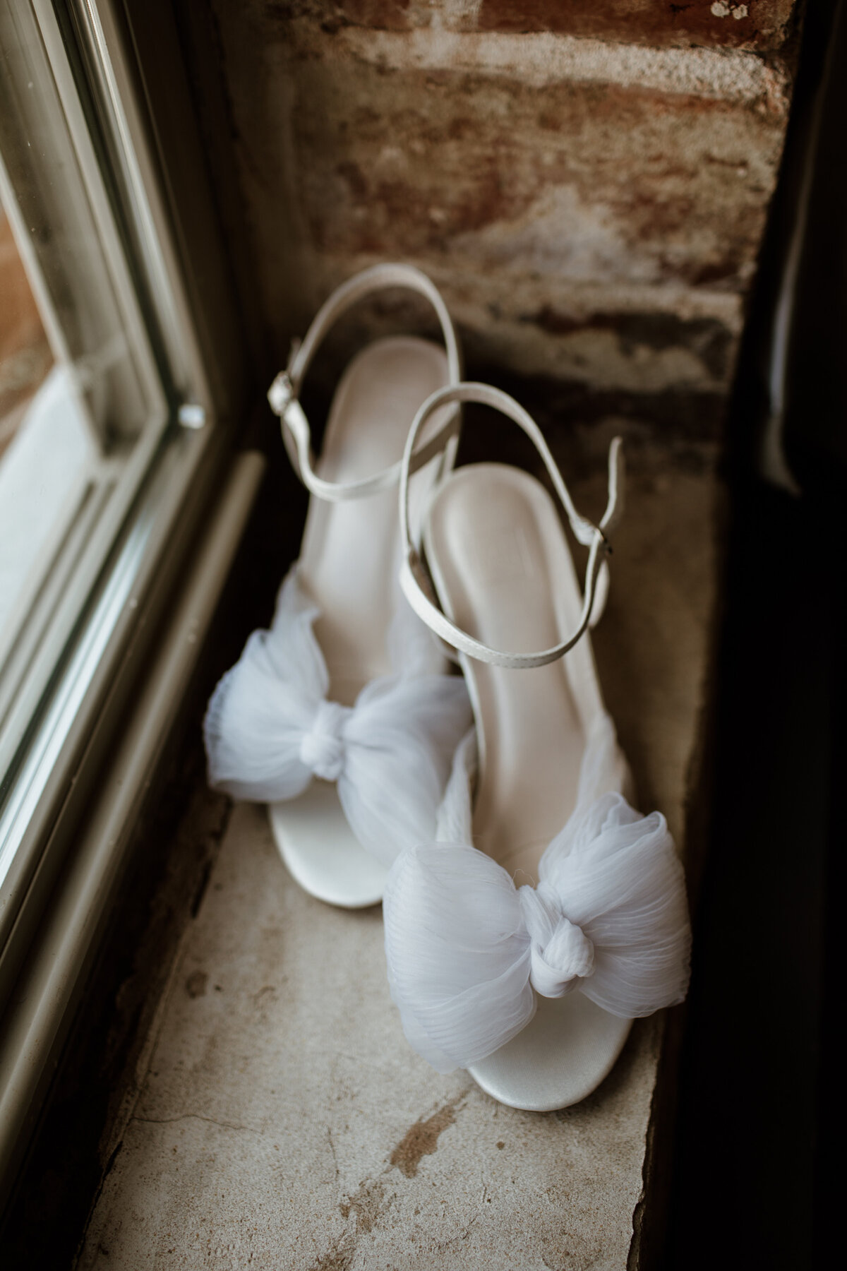 Bridal shoes with a bow captured by Fort Worth wedding photographer, Megan Christine Studio