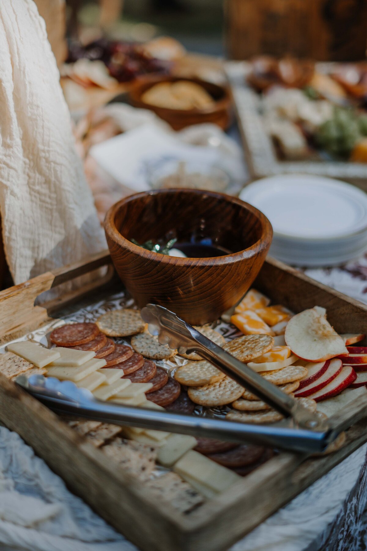 cheeses placed on a wooden board at a wedding reception