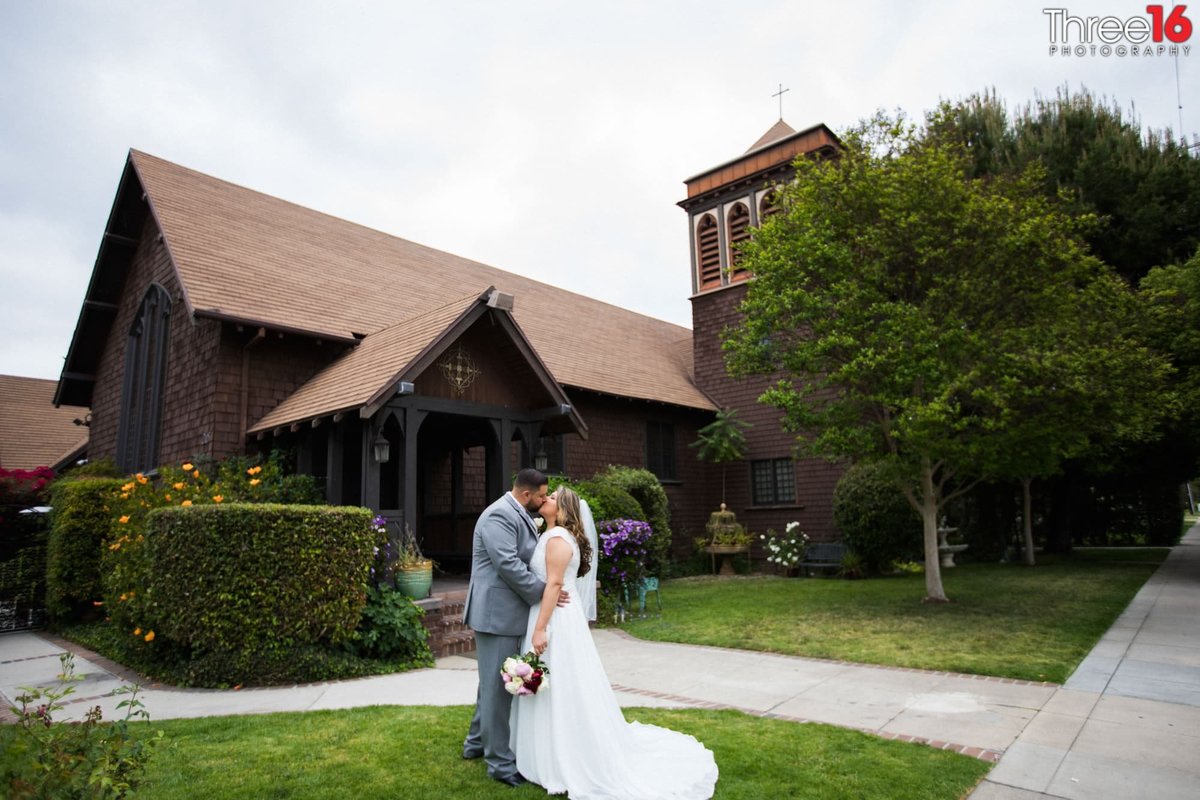 Bride and Groom share a kiss in front of The Chapel of Orange