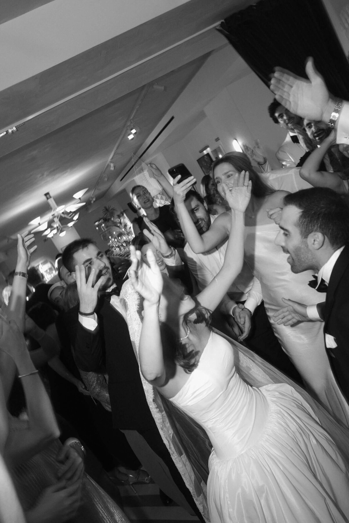 Guests and singers dancing together during vibrant wedding celebration

