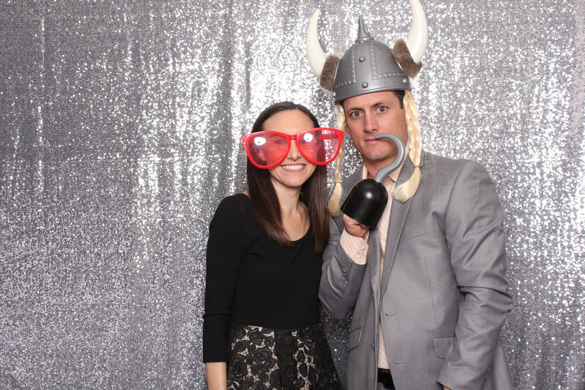 Man and Woman pose with photo booth rental props