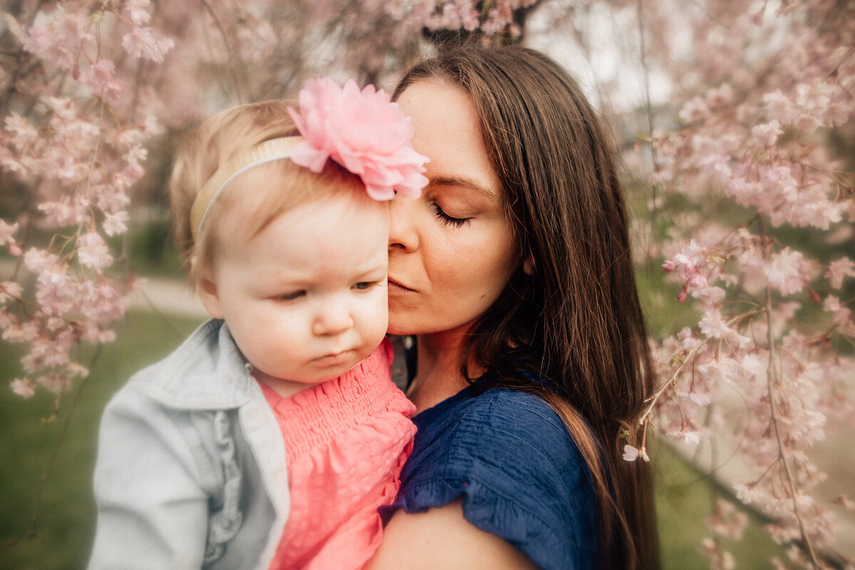 Mom holds daughter.
