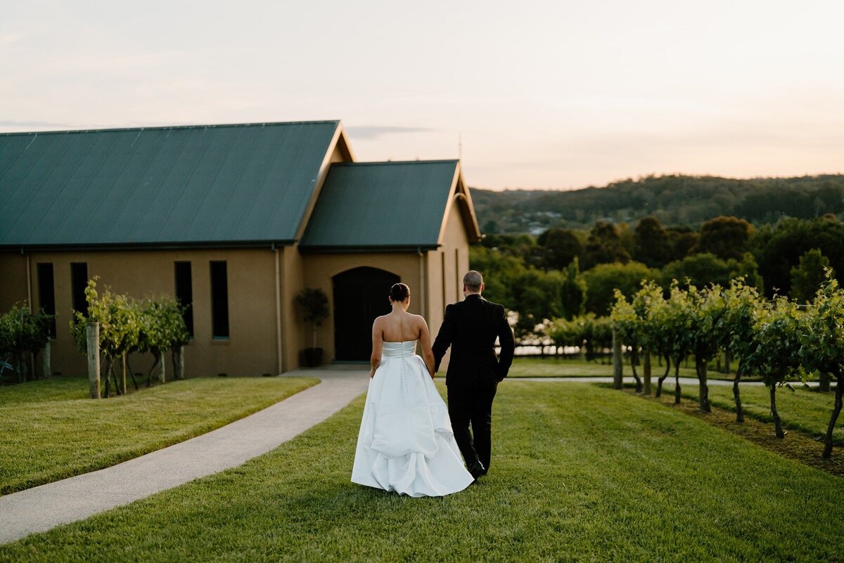 A bride and groom walking away from the camera at Vue on Halcyon