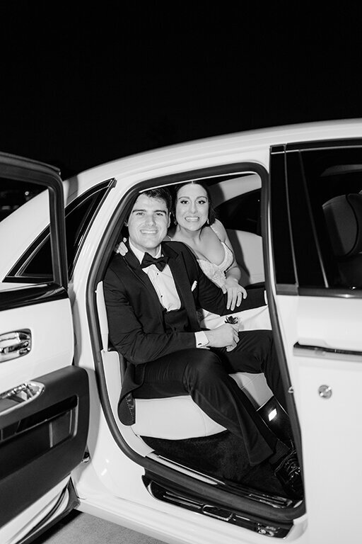 Bride and groom sitting in getaway car for wedding exit at The Olana, Dallas