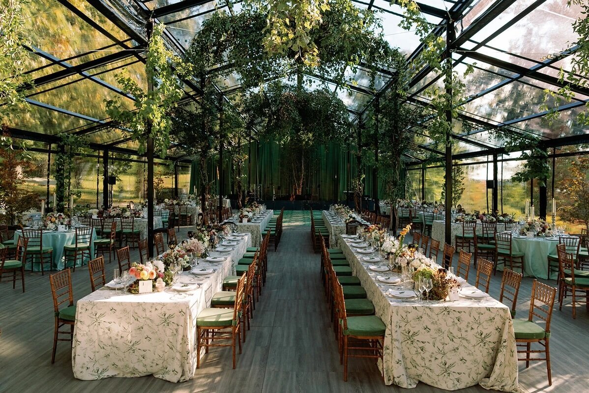 Symmetrical reception layout with greenery overhead and sculptural florals, styled as inspiration for Sycamore Bend Estate weddings