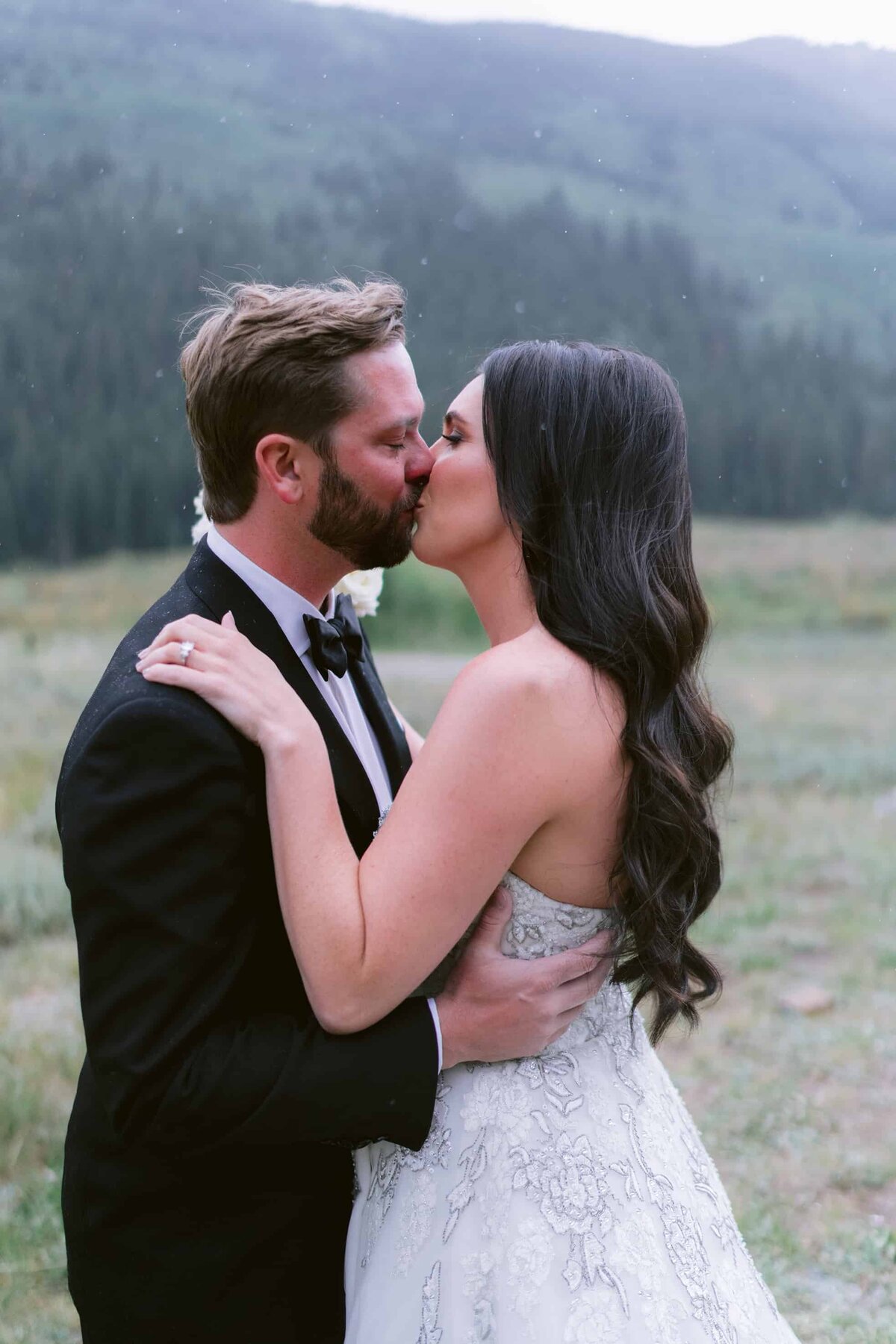 Bride and groom sharing a kiss at a custom designed wedding in Aspen Colorado