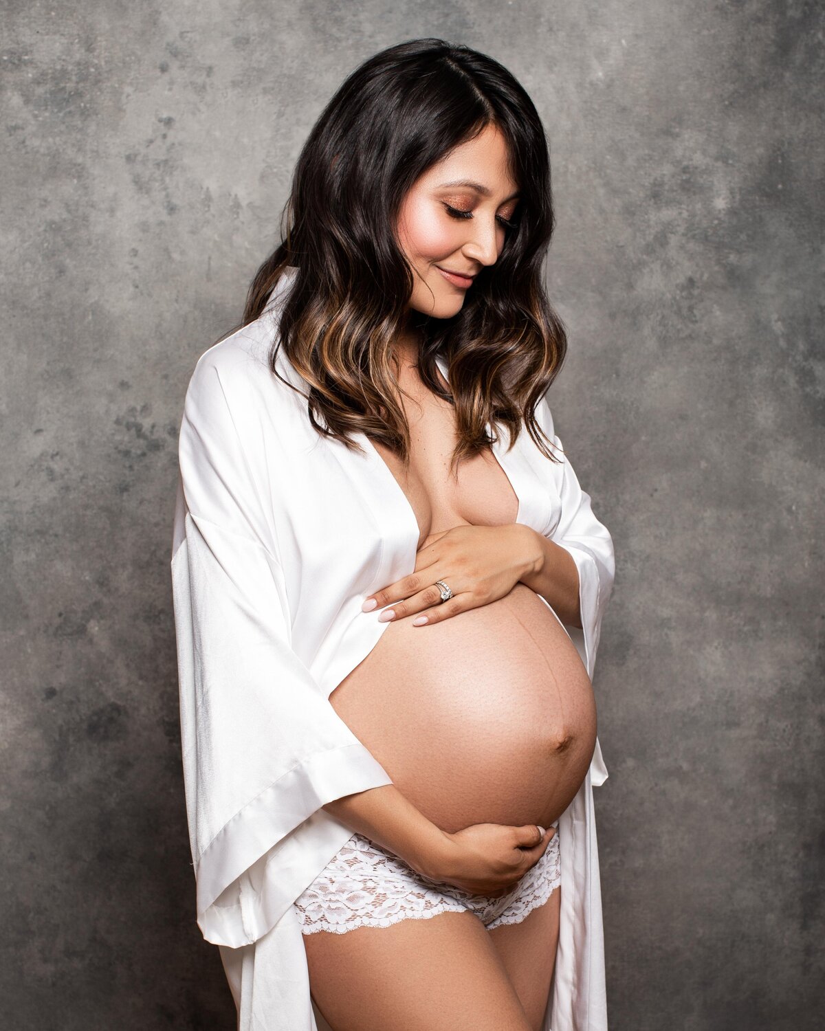 Maternity photography of a woman wearing a silky robe