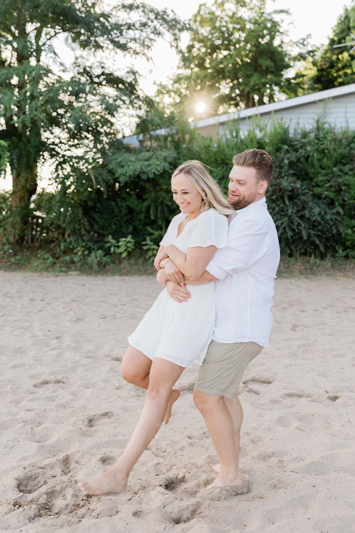 Newlywed couple laughing on a beach