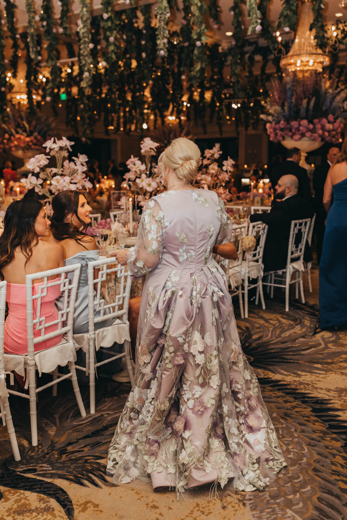 mother of the bride in her couture floral dress matching the floral theme of the wedding