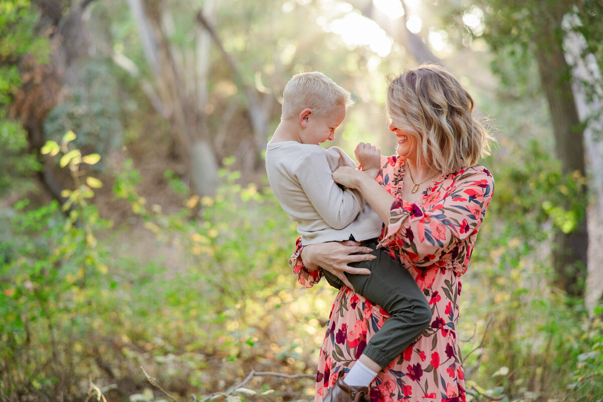 mom and son laugh in glowy light