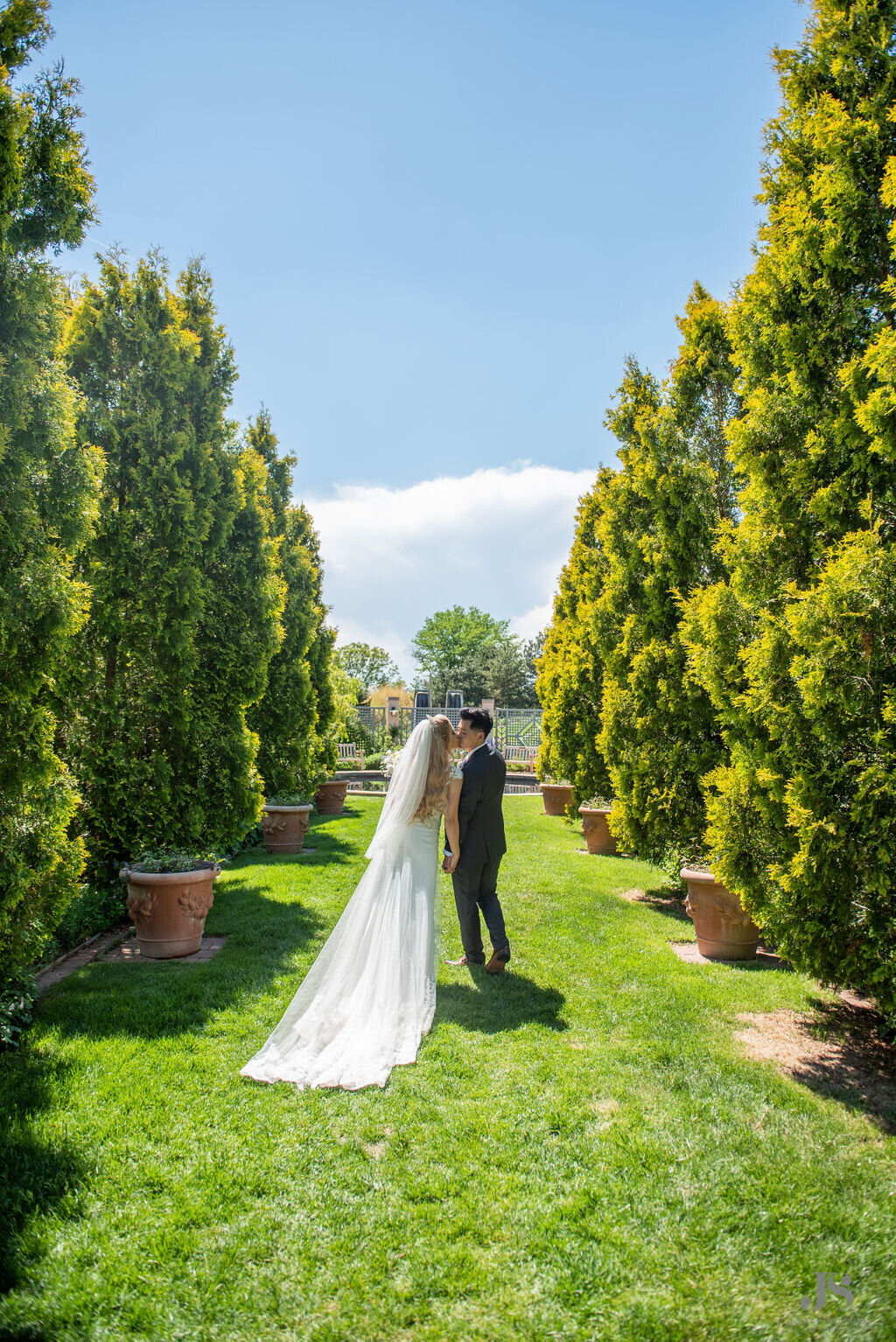 Bride and Groom kiss in a garden.