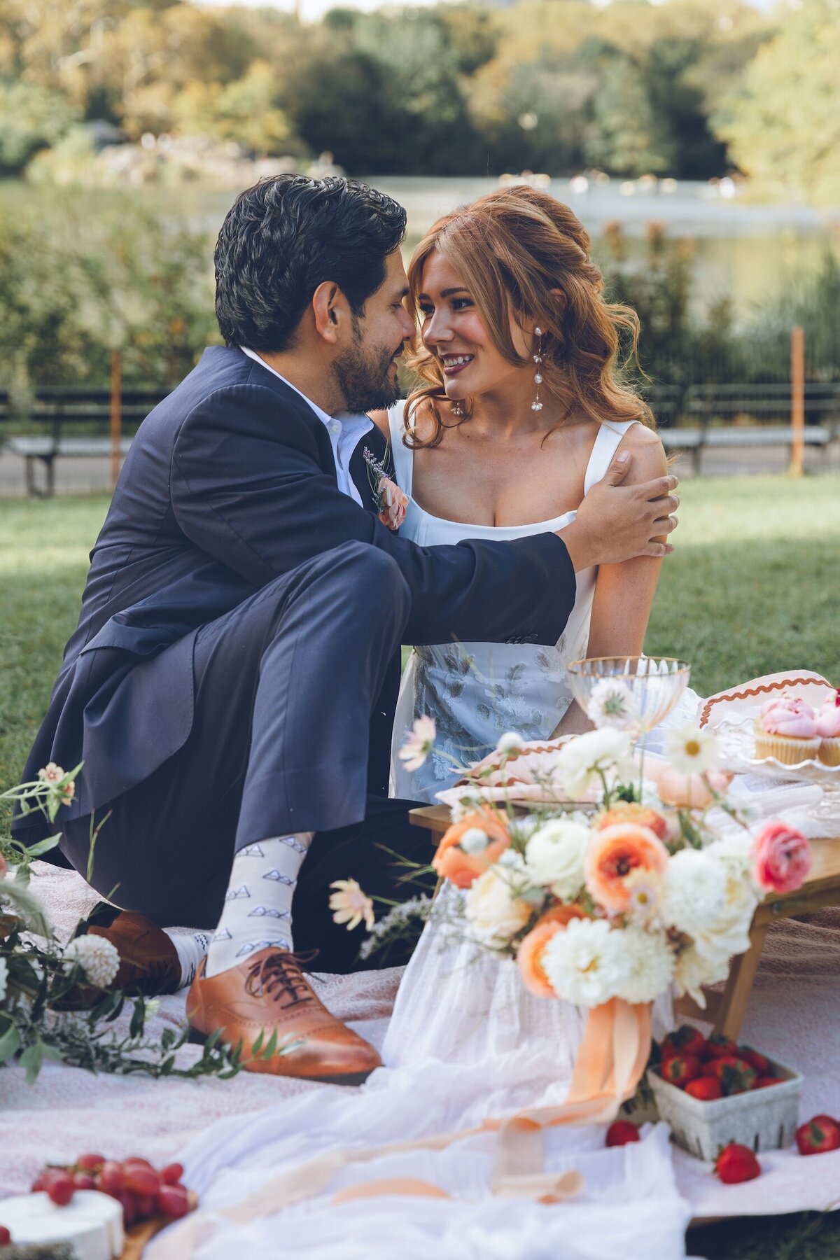 Intimate moment of couple sitting on picnic blanket