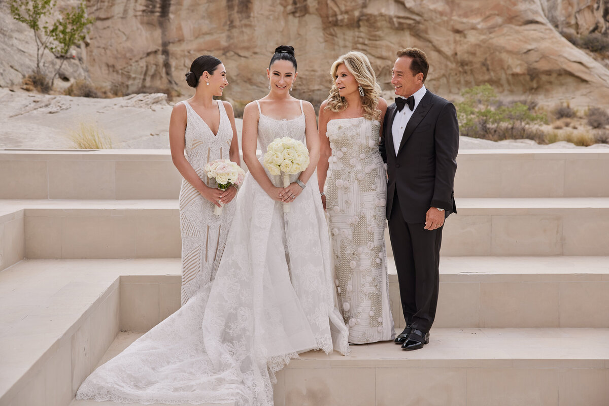 Bride with her mother father ad=nd sister on steps at Amangiri Utah