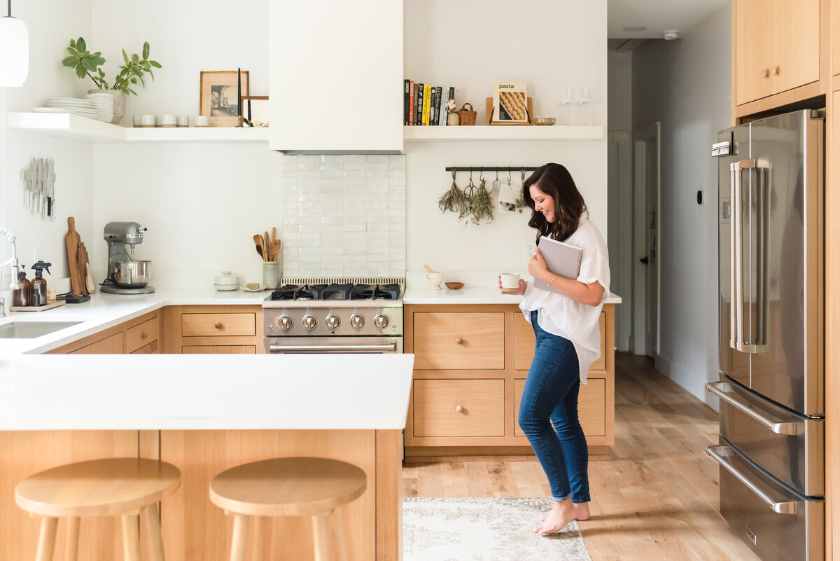 Madison Dearly in a kitchen holding a notebook