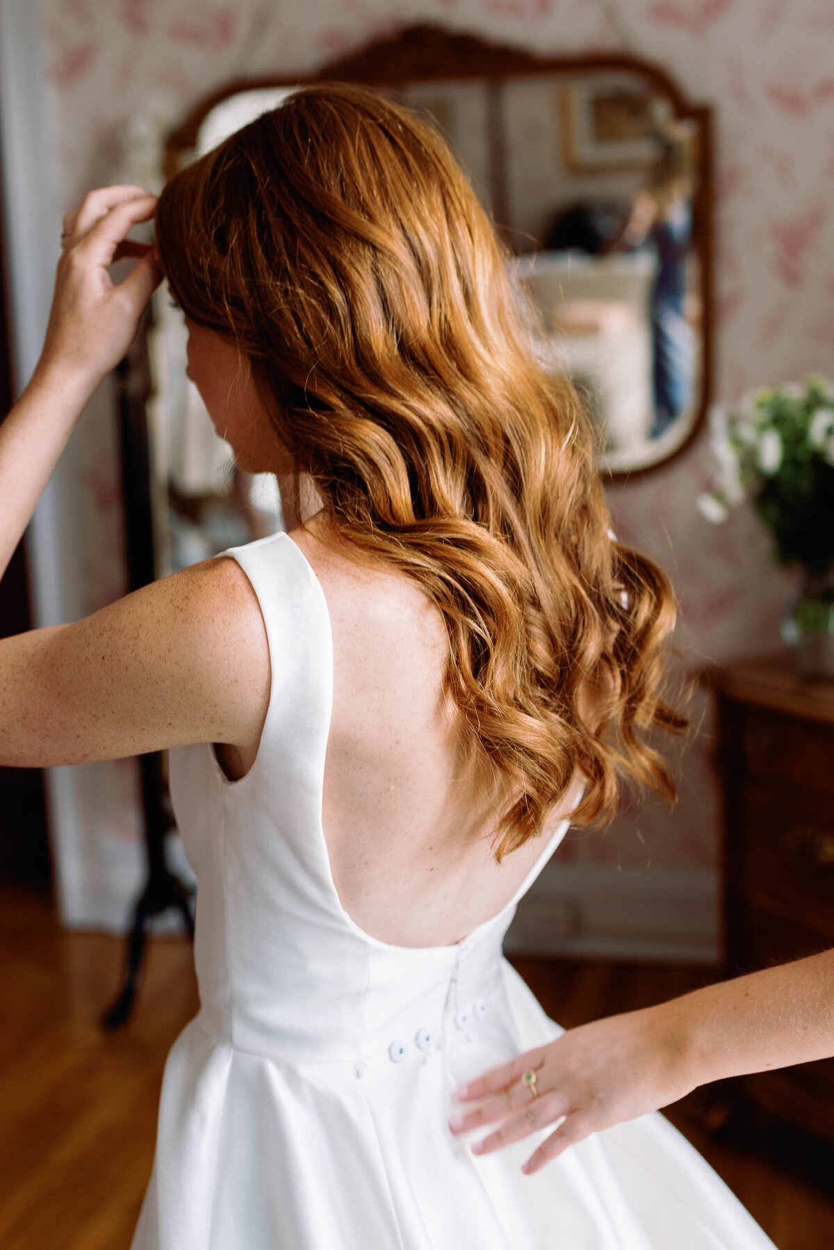 red haired bride with hollywood waves cascading down her back in sareh nouri gown