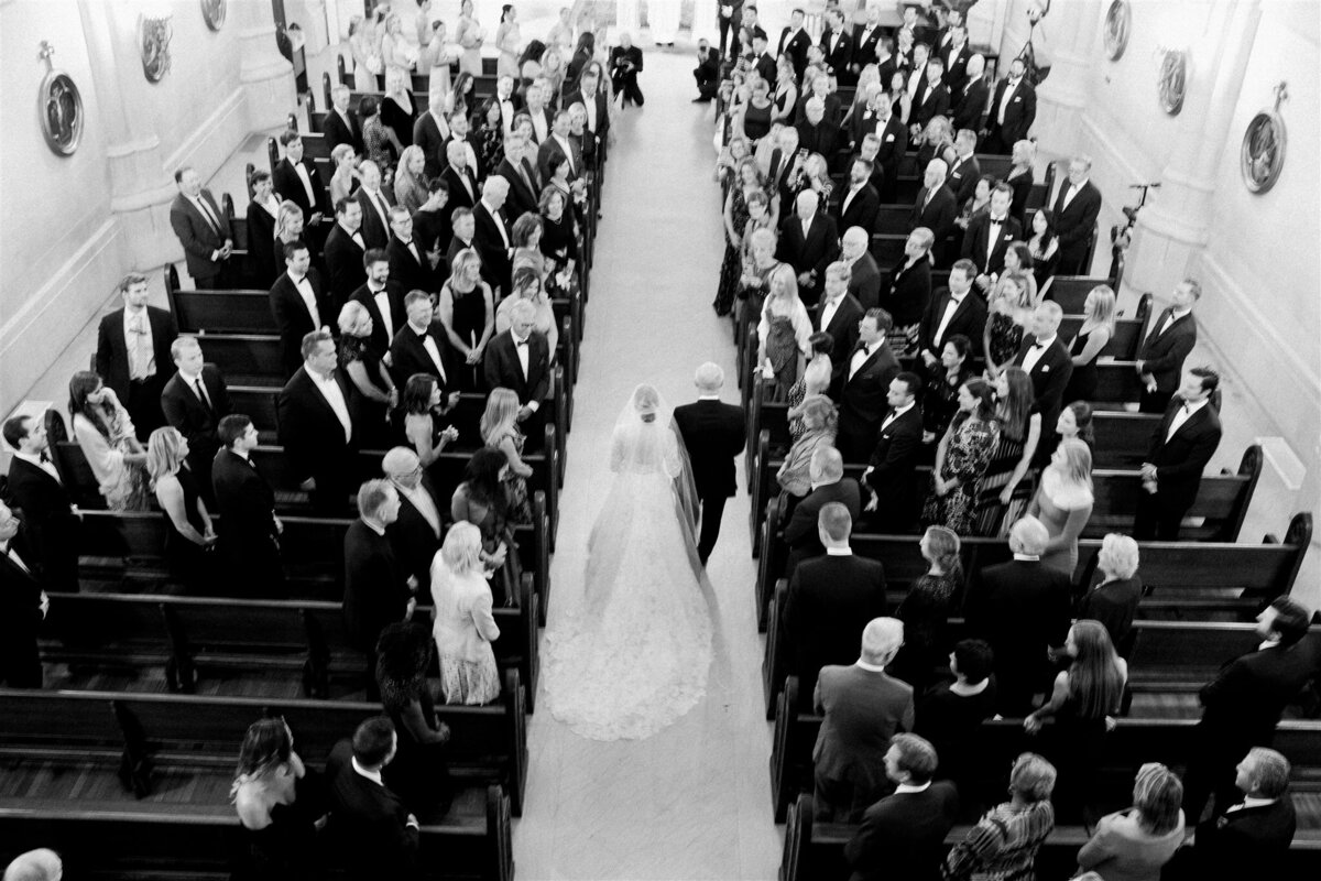 A picture of the bride walking down the aisle to the alter. 