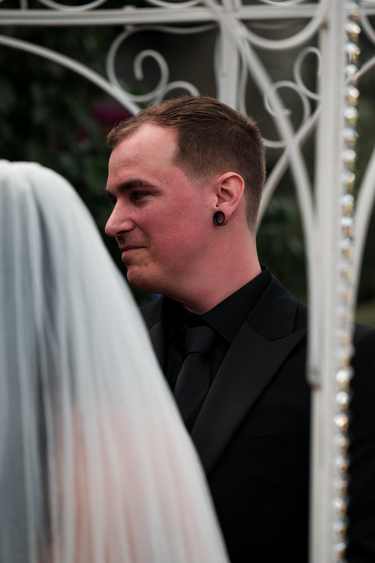 close up of a grooms reaction to his bride walking down the isle