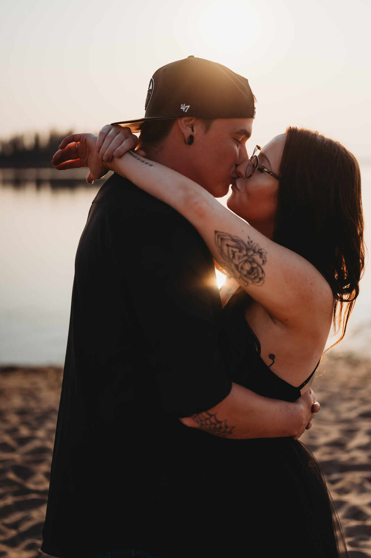 engaged couple share a kiss