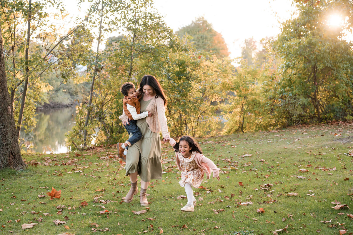 Mom playfully running with kids