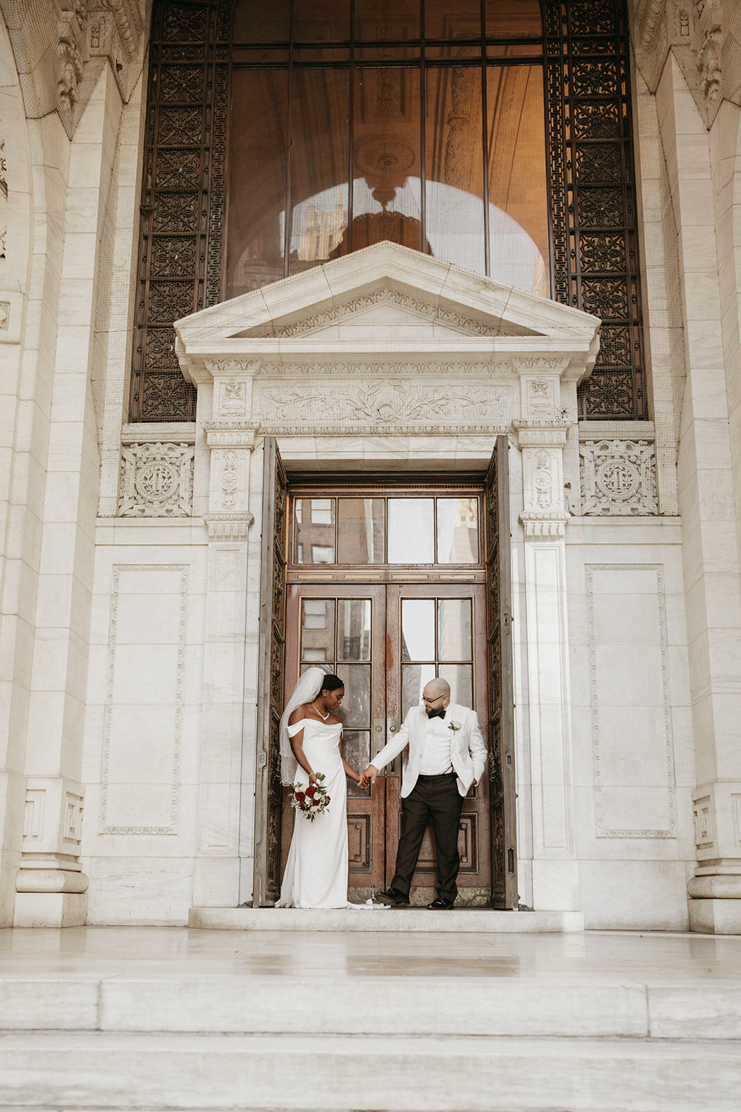 black couple holding hands on wedding day
