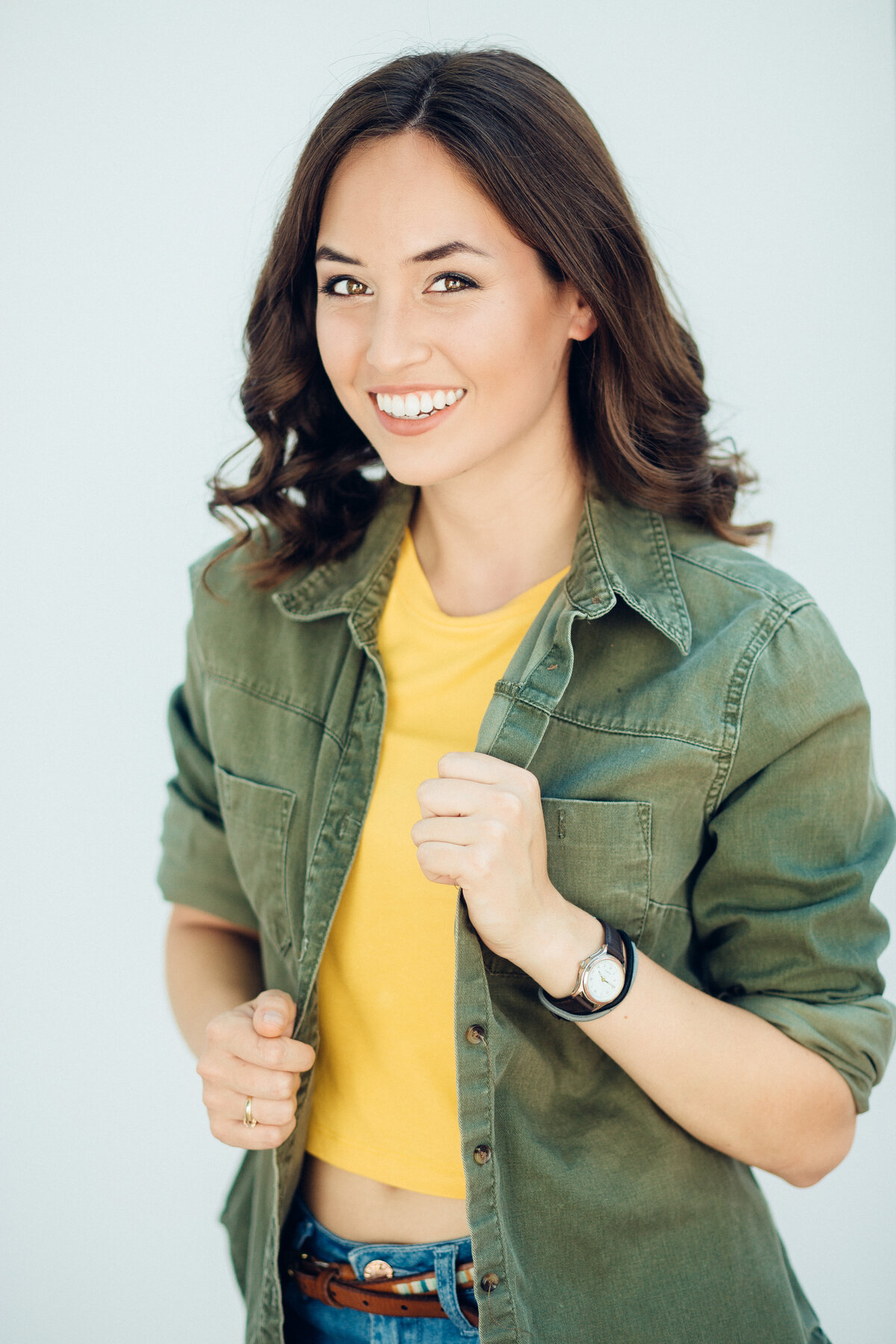 Headshot Photograph Of Young Woman In Army Green Jacket And Inner Yellow Crop Top Los Angeles