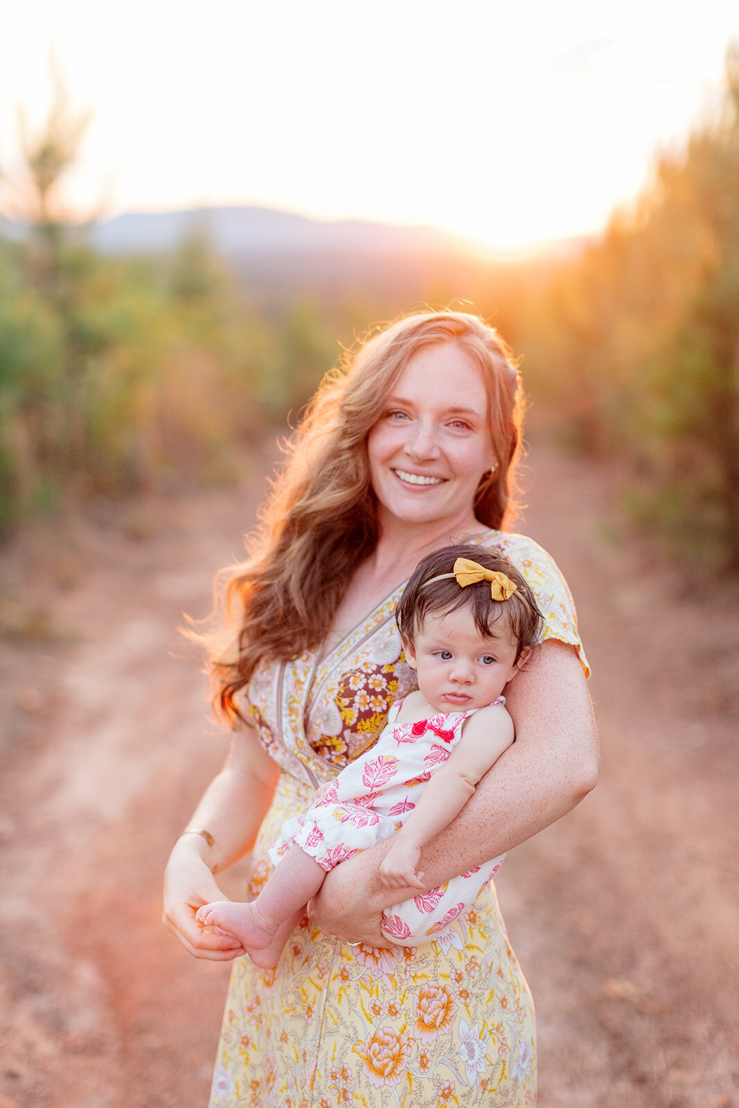 Parents cuddling their baby during golden hour portrait session