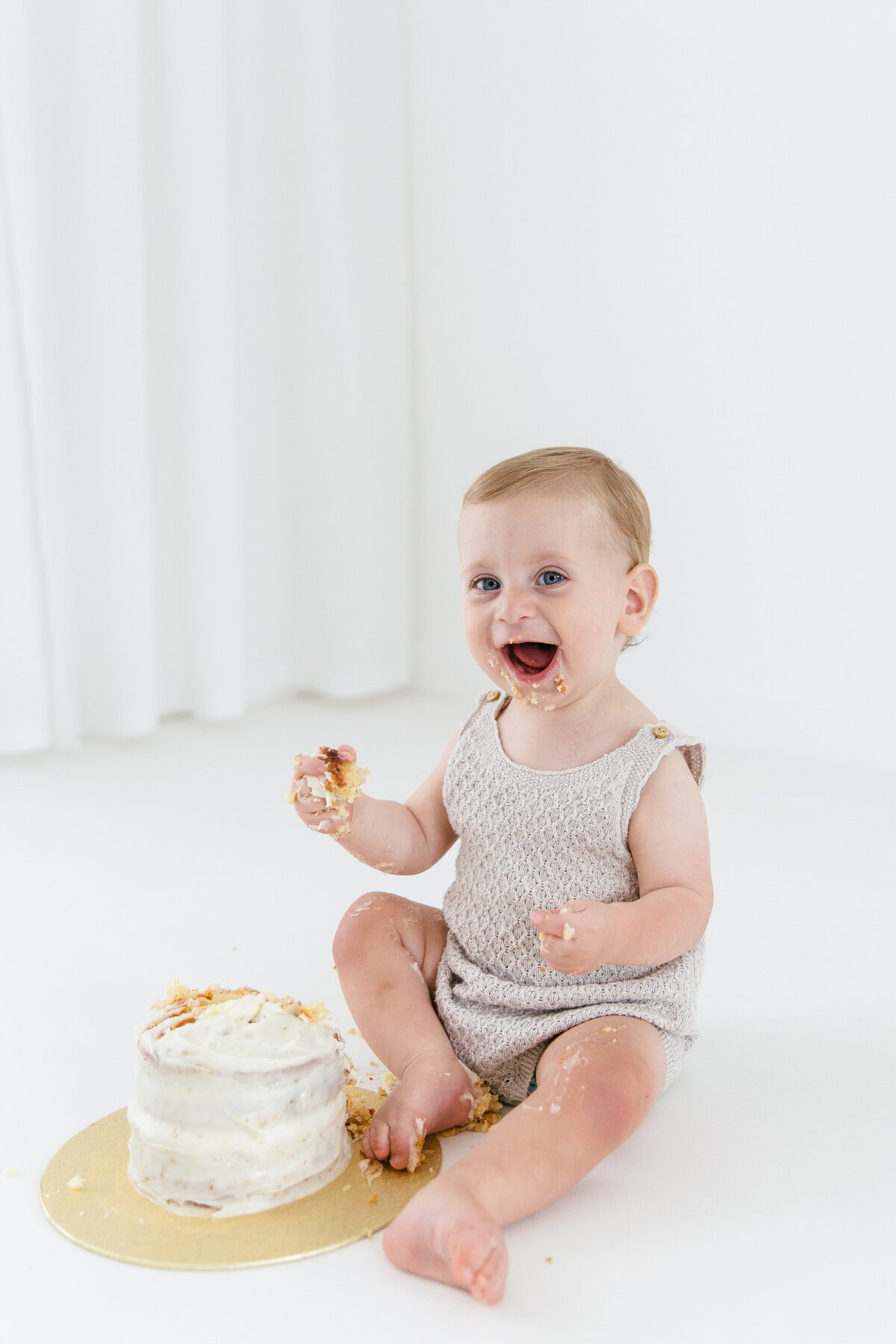 one year old enjoying cake