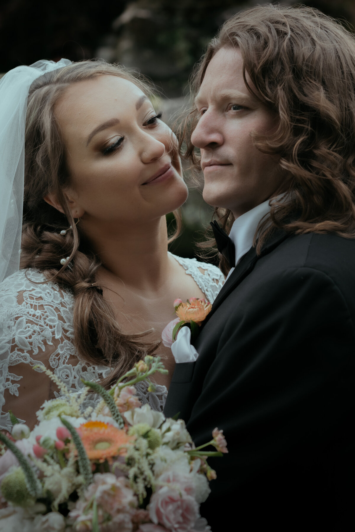 A bride looks affectionately at the groom in a cinematic portrait shot with Pride and Prejudice vibes.