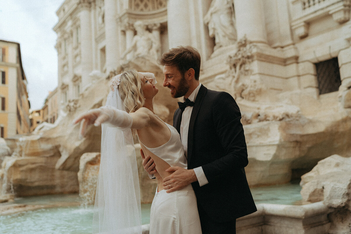 couple eloping at the trevi fountain in rome, captured by destination wedding photographer Elsie Goodman
