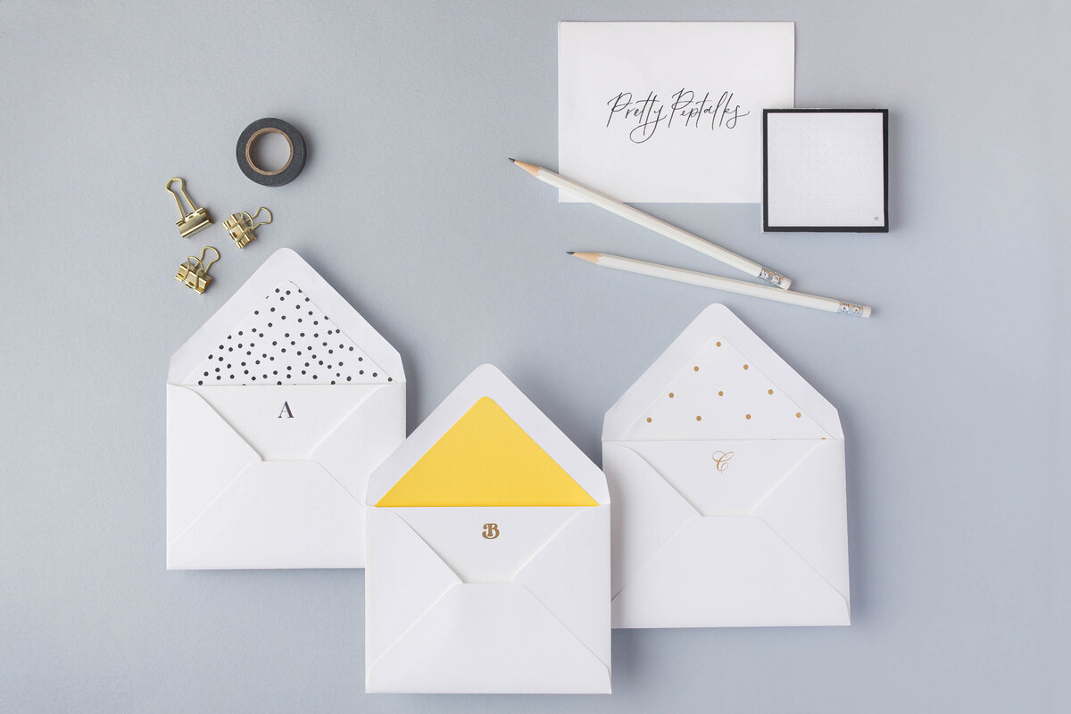 a flat lay of envelopes and stationery supplies