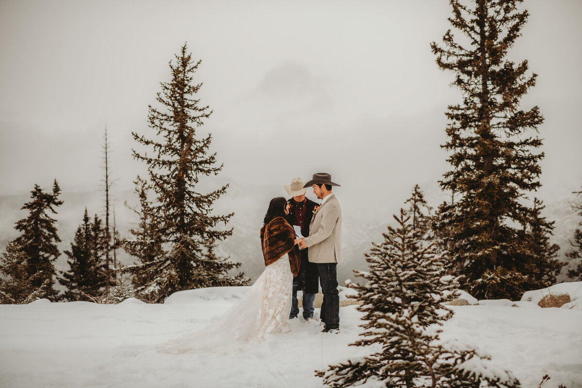 bride and groom at their snowy elopement ceremony taken by colorado elopement photographer