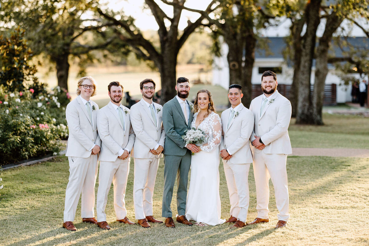 bride and groom with groomsmen after wedding ceremony