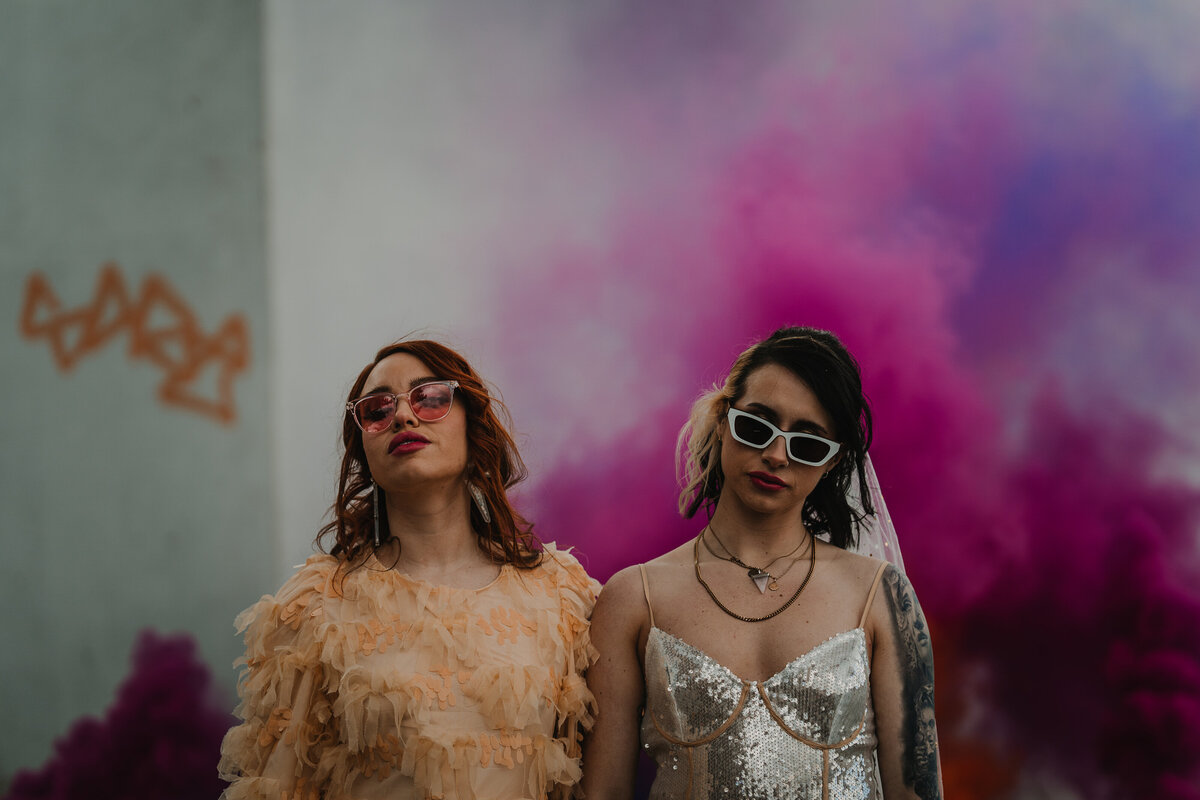 Cool wedding photography of two brides with smoke bombs